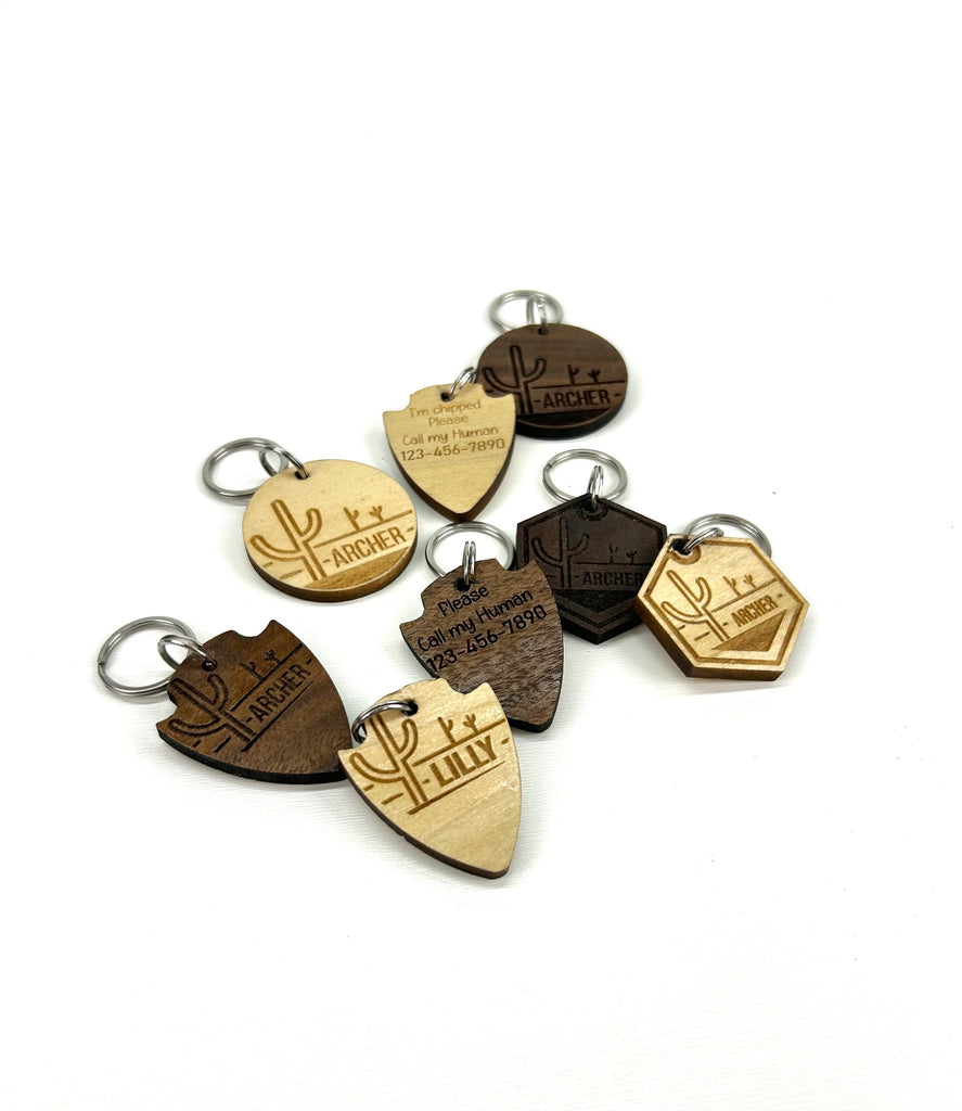6 wooden laser engraved personalized dog ID tags (3 walnut  & 3 poplar woods) with 3 different shape options ( round, hexagon, & arrowhead) with ? background.